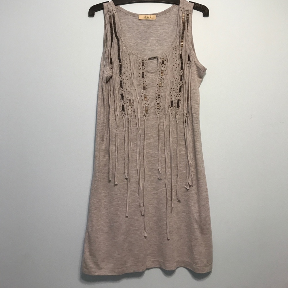 Sleeveless gray tunic with decorative beads.